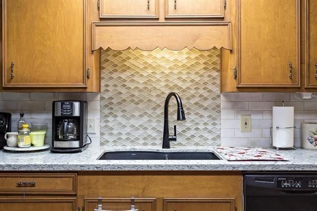 527 E Walton Rd, Lumberton, TX 77657 - kitchen featuring black dishwasher, a sink, decorative backsplash, and brown cabinets