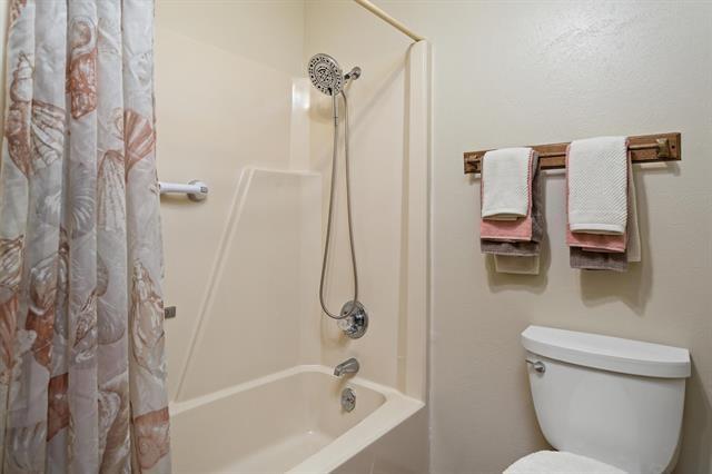 527 E Walton Rd, Lumberton, TX 77657 - full bathroom with toilet and shower / tub combo with curtain