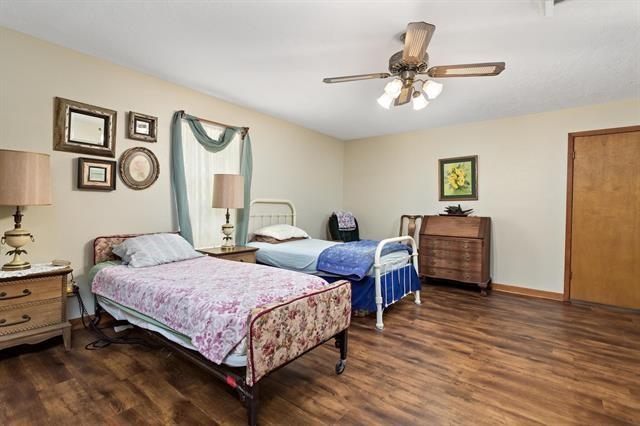 527 E Walton Rd, Lumberton, TX 77657 - bedroom with wood finished floors, ceiling fan, and baseboards