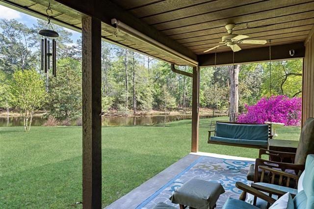 527 E Walton Rd, Lumberton, TX 77657 - sunroom / solarium with ceiling fan, a water view, and view of wooded area
