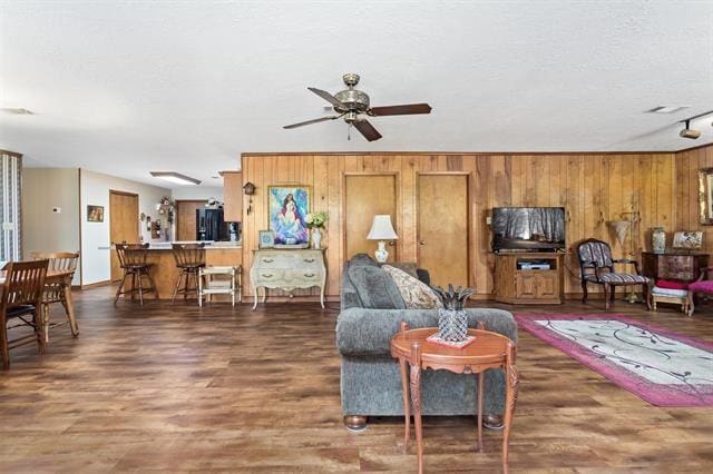 527 E Walton Rd, Lumberton, TX 77657 - living area with wood walls, ceiling fan, and wood finished floors