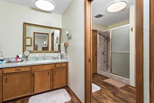 527 E Walton Rd, Lumberton, TX 77657 - full bathroom with wood finished floors, a shower stall, and vanity