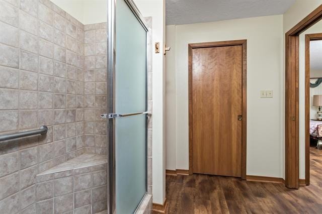 527 E Walton Rd, Lumberton, TX 77657 - full bath featuring wood finished floors, a shower stall, ensuite bathroom, and baseboards