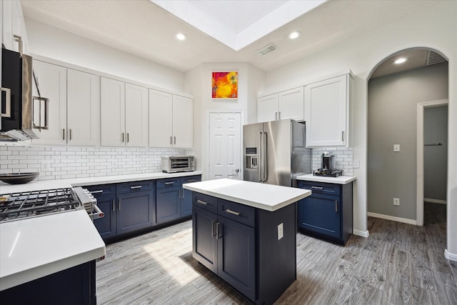 9014 Lavender Field Ct, Sugar Land, TX 77479 - kitchen with high end refrigerator, blue cabinetry, light countertops, backsplash, and recessed lighting