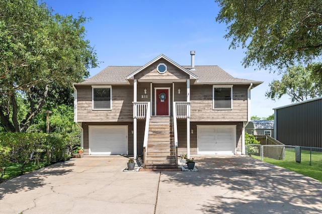 211 4th St, Dickinson, TX 77539 - beach home with stairs, an attached garage, driveway, and fence