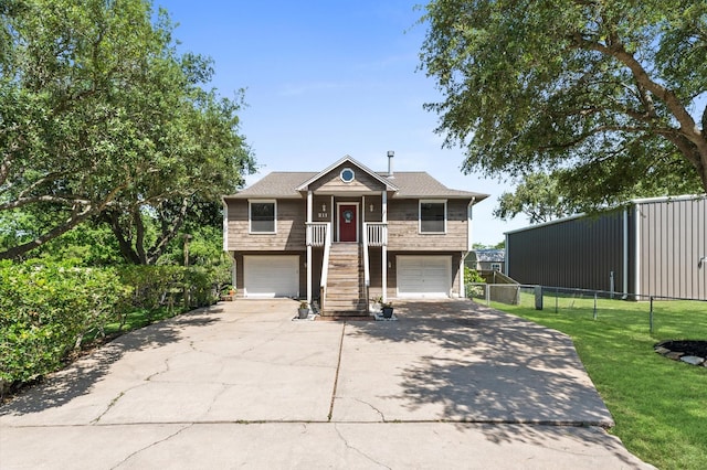 211 4th St, Dickinson, TX 77539 - view of front facade featuring driveway, an attached garage, and stairs