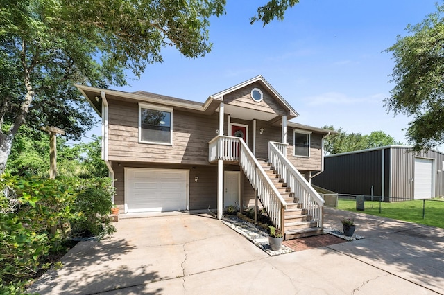 211 4th St, Dickinson, TX 77539 - view of front facade featuring concrete driveway, an attached garage, stairway, and fence