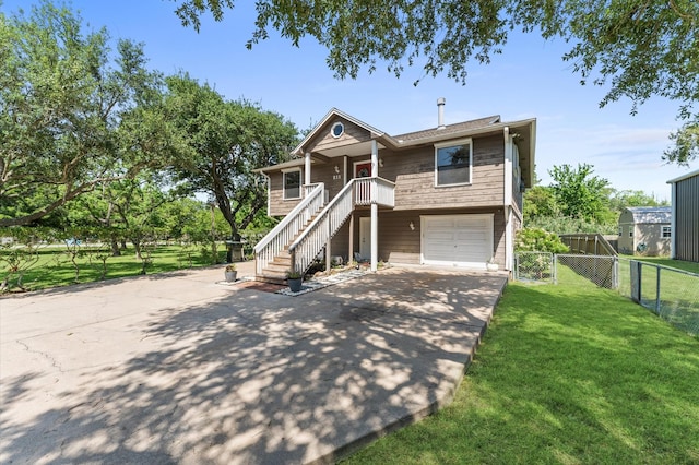 211 4th St, Dickinson, TX 77539 - view of front of house with driveway, an attached garage, and stairway