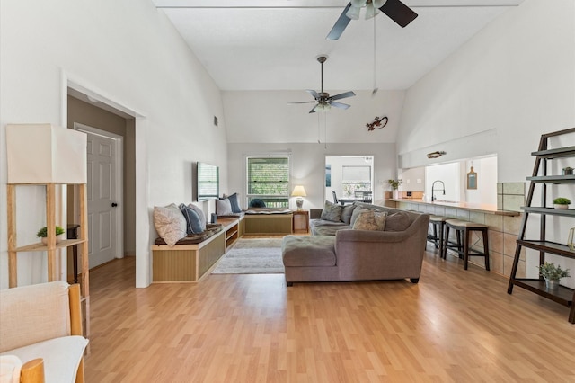 211 4th St, Dickinson, TX 77539 - living room with a ceiling fan, light wood-style flooring, and high vaulted ceiling