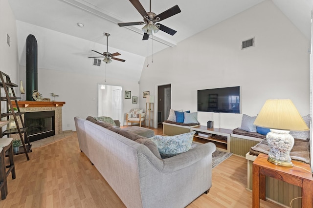 211 4th St, Dickinson, TX 77539 - living area with a ceiling fan, light wood-type flooring, high vaulted ceiling, attic access, and beam ceiling