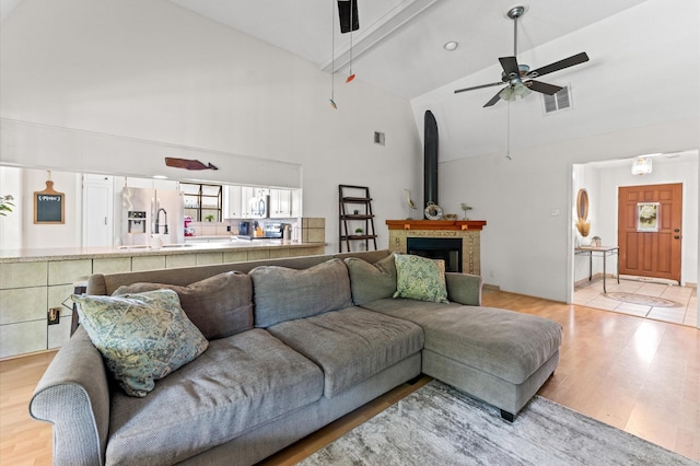 211 4th St, Dickinson, TX 77539 - living area with ceiling fan, high vaulted ceiling, and light wood-style flooring