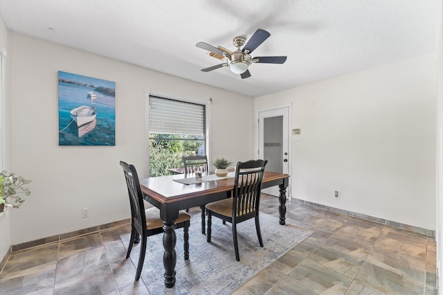 211 4th St, Dickinson, TX 77539 - dining space with ceiling fan, baseboards, and stone finish flooring