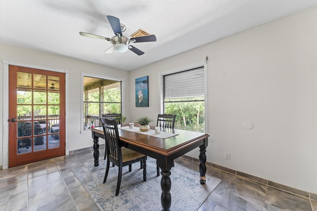 211 4th St, Dickinson, TX 77539 - dining area featuring a ceiling fan and baseboards