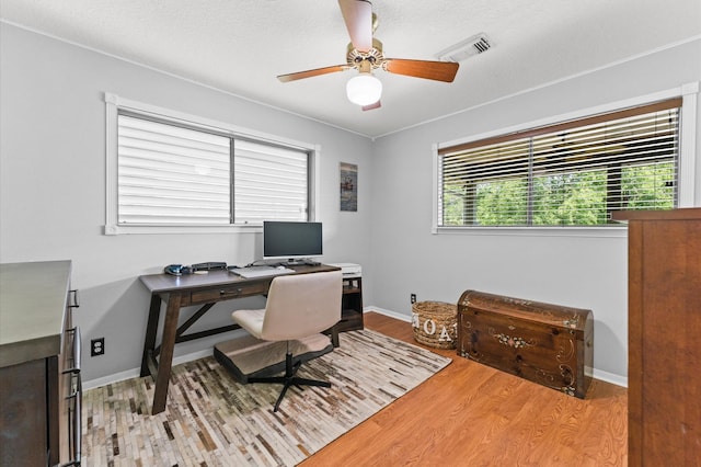 211 4th St, Dickinson, TX 77539 - home office with light wood finished floors, ceiling fan, and baseboards