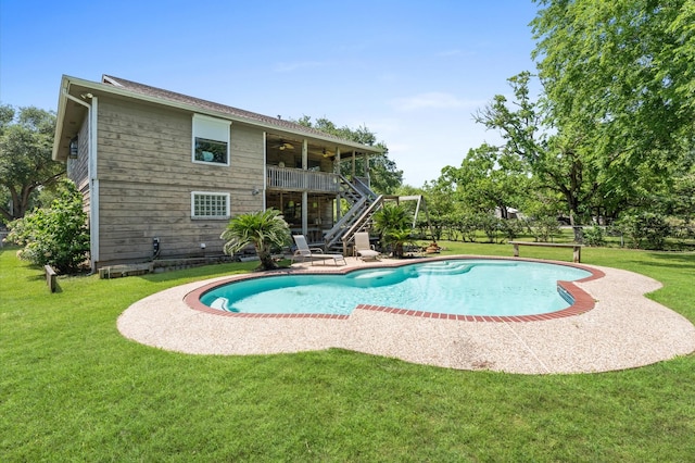 211 4th St, Dickinson, TX 77539 - outdoor pool featuring stairs, a ceiling fan, a lawn, and a patio area