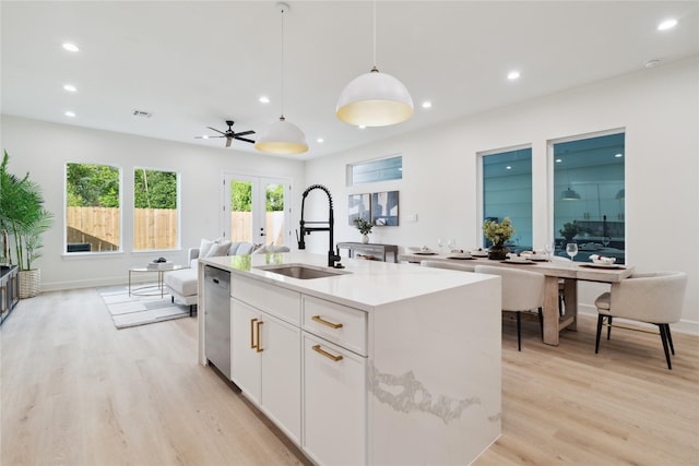 3731 Lydia St, Houston, TX 77021 - kitchen featuring a sink, light wood-style floors, decorative light fixtures, a kitchen island with sink, and dishwasher