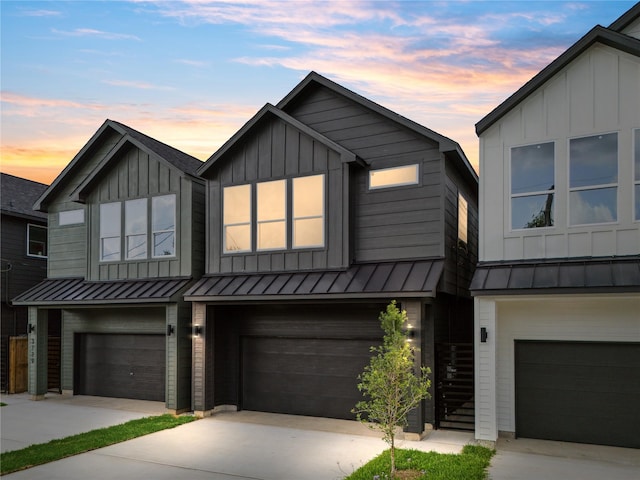3731 Lydia St, Houston, TX 77021 - view of front of property featuring a standing seam roof, board and batten siding, a garage, driveway, and metal roof