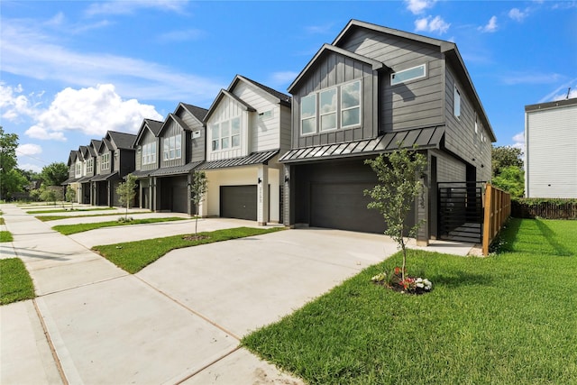 3731 Lydia St, Houston, TX 77021 - view of property featuring an attached garage, concrete driveway, a standing seam roof, board and batten siding, and a residential view