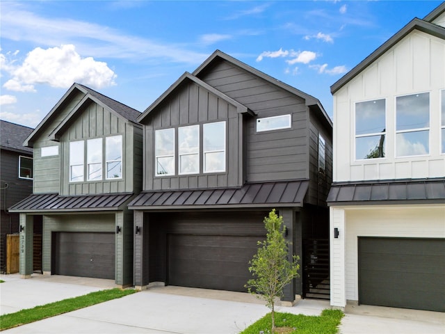 3731 Lydia St, Houston, TX 77021 - view of front of property featuring board and batten siding, a standing seam roof, a garage, driveway, and metal roof