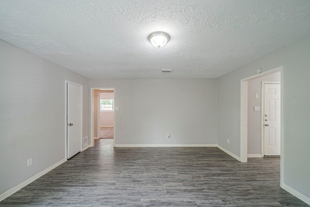 7218 Winding Trace Dr, Houston, TX 77086 - unfurnished room with wood finished floors, a textured ceiling, and baseboards
