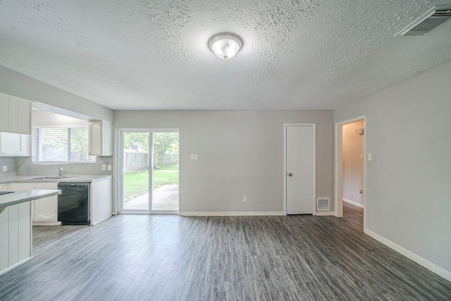 7218 Winding Trace Dr, Houston, TX 77086 - unfurnished living room with a textured ceiling, wood finished floors, baseboards, and a sink