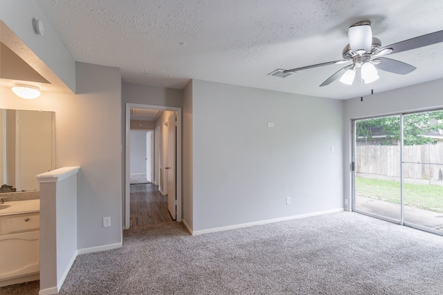 7218 Winding Trace Dr, Houston, TX 77086 - spare room with attic access, carpet, ceiling fan, a textured ceiling, and baseboards