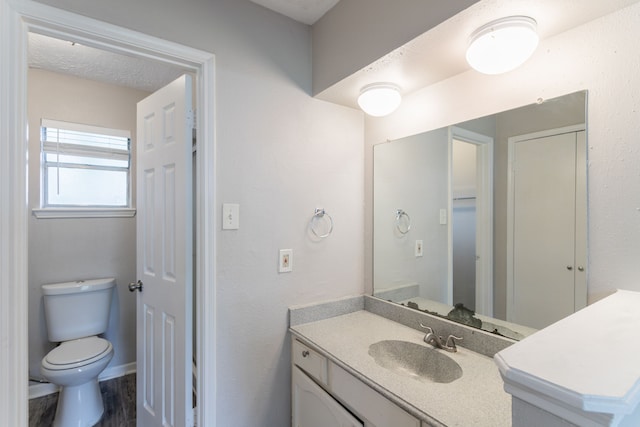 7218 Winding Trace Dr, Houston, TX 77086 - bathroom with toilet, vanity, and wood finished floors