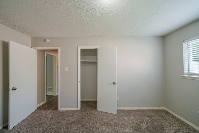 7218 Winding Trace Dr, Houston, TX 77086 - unfurnished bedroom with a textured ceiling, carpet flooring, a closet, and baseboards