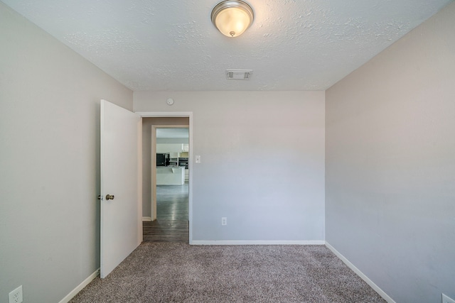 7218 Winding Trace Dr, Houston, TX 77086 - carpeted spare room featuring a textured ceiling and baseboards