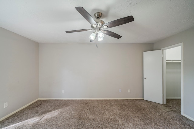 7218 Winding Trace Dr, Houston, TX 77086 - unfurnished bedroom featuring carpet, a walk in closet, ceiling fan, and baseboards
