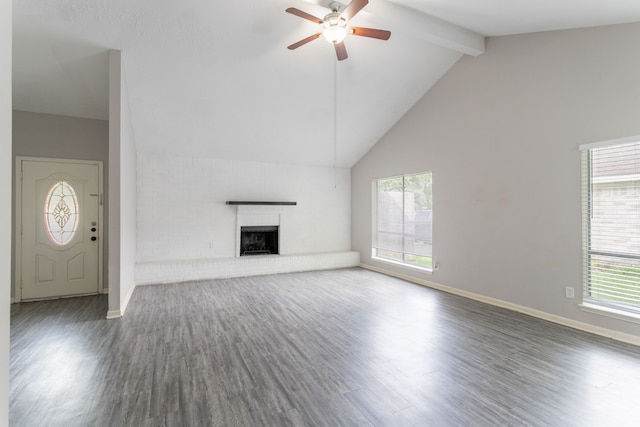7218 Winding Trace Dr, Houston, TX 77086 - unfurnished living room featuring ceiling fan, wood finished floors, high vaulted ceiling, healthy amount of natural light, and beam ceiling