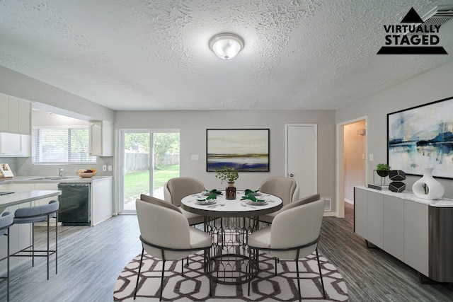 7218 Winding Trace Dr, Houston, TX 77086 - dining space featuring light wood finished floors, a textured ceiling, and baseboards