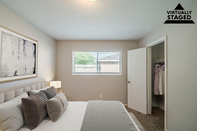 7218 Winding Trace Dr, Houston, TX 77086 - bedroom featuring a textured ceiling, a walk in closet, carpet, and a closet