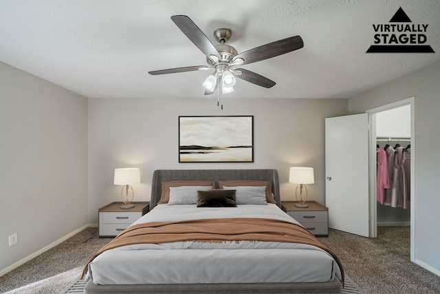 7218 Winding Trace Dr, Houston, TX 77086 - bedroom featuring carpet flooring, a spacious closet, ceiling fan, and baseboards