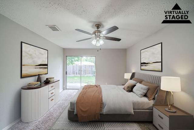 7218 Winding Trace Dr, Houston, TX 77086 - carpeted bedroom with access to exterior, a textured ceiling, baseboards, and ceiling fan