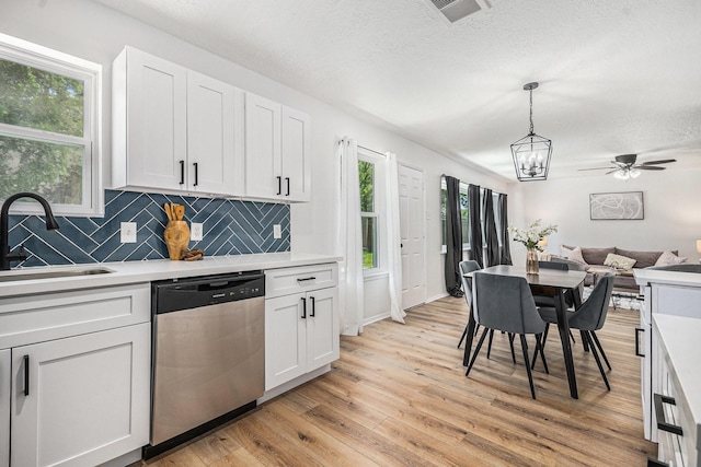 763 Voyager Dr, Houston, TX 77062 - kitchen with dishwasher, a sink, light wood-style floors, decorative backsplash, and light countertops