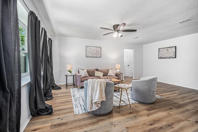 763 Voyager Dr, Houston, TX 77062 - living area with wood finished floors, a ceiling fan, baseboards, and a textured ceiling