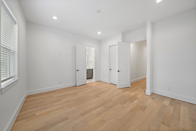 1435 Laird St, Houston, TX 77008 - unfurnished bedroom with light wood-type flooring, baseboards, recessed lighting, and ensuite bath