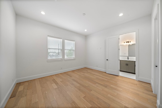 1435 Laird St, Houston, TX 77008 - unfurnished bedroom with light wood-type flooring, baseboards, recessed lighting, and ensuite bath