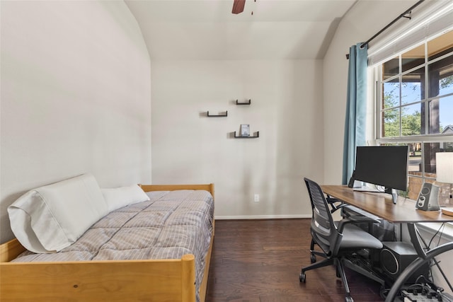 bedroom featuring lofted ceiling, dark wood-style flooring, an office area, baseboards, and a ceiling fan