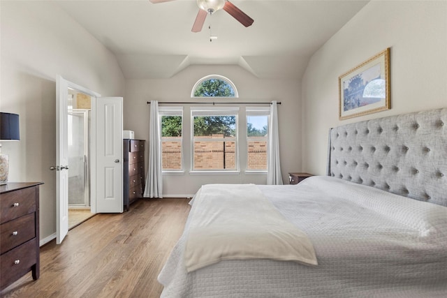bedroom with wood finished floors, lofted ceiling, and ceiling fan