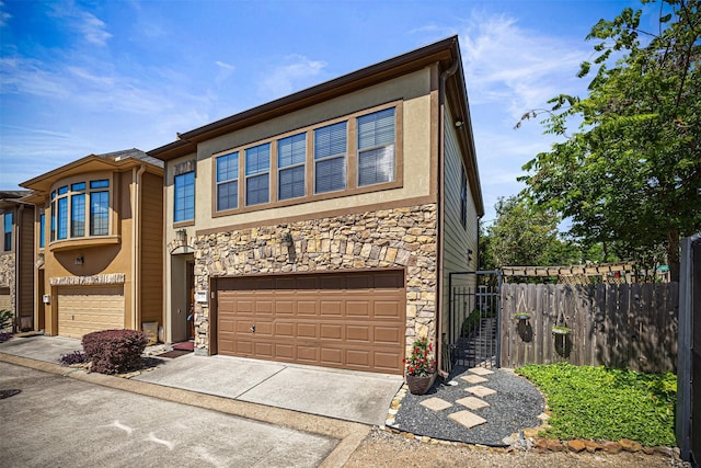 1380 Studer St, Houston, TX 77007 - view of front of house featuring stone siding, a garage, fence, concrete driveway, and stucco siding
