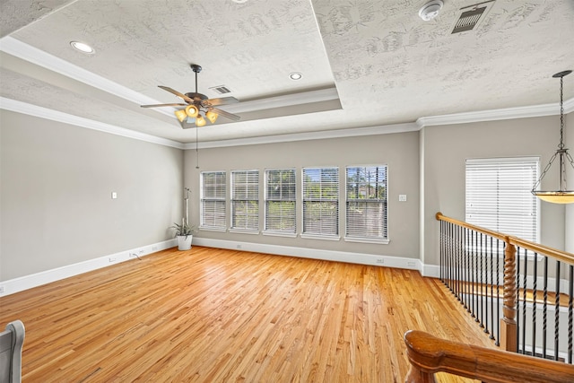 1380 Studer St, Houston, TX 77007 - unfurnished room featuring baseboards, a ceiling fan, light wood finished floors, a raised ceiling, and ornamental molding