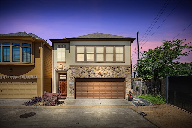 1380 Studer St, Houston, TX 77007 - view of front of house with driveway, stucco siding, fence, stone siding, and a garage