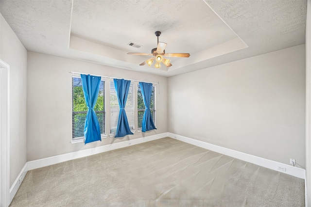 1380 Studer St, Houston, TX 77007 - carpeted empty room featuring a textured ceiling, baseboards, a raised ceiling, and ceiling fan