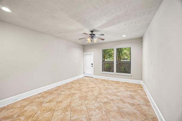 1380 Studer St, Houston, TX 77007 - spare room with a ceiling fan, a textured ceiling, recessed lighting, baseboards, and light tile patterned floors
