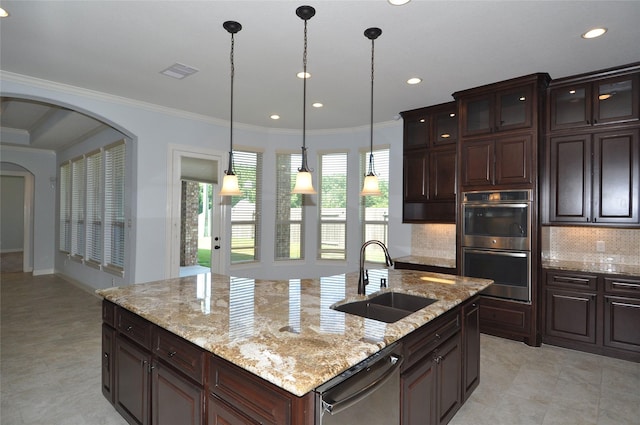15818 Tremout Hollow Ln, Houston, TX 77044 - kitchen featuring a sink, appliances with stainless steel finishes, backsplash, arched walkways, and hanging light fixtures