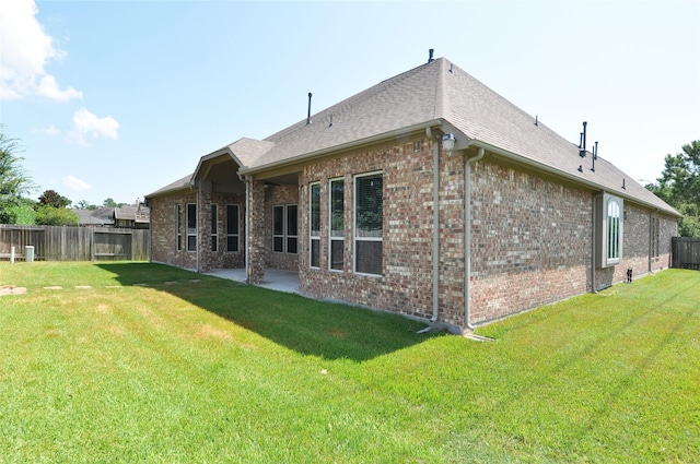 15818 Tremout Hollow Ln, Houston, TX 77044 - rear view of house with brick siding, a patio area, and a shingled roof