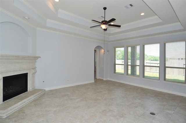 15818 Tremout Hollow Ln, Houston, TX 77044 - unfurnished living room with a raised ceiling, ceiling fan, arched walkways, ornamental molding, and recessed lighting