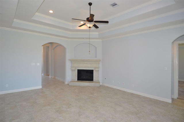 15818 Tremout Hollow Ln, Houston, TX 77044 - unfurnished living room with arched walkways, a ceiling fan, a raised ceiling, a fireplace with raised hearth, and ornamental molding